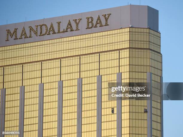 Broken windows are seen on the 32nd floor of the Mandalay Bay Resort and Casino after a lone gunman opened fire on the Route 91 Harvest country music...