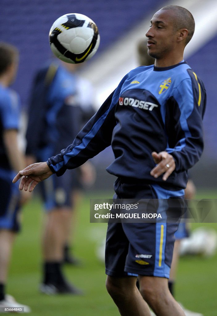 Sweden's player Henrik Larsson plays wit