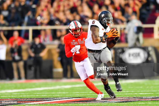 Keenen Brown of the Oklahoma State Cowboys looks for yards after making the catch during the game against the Texas Tech Red Raiders on September 30,...