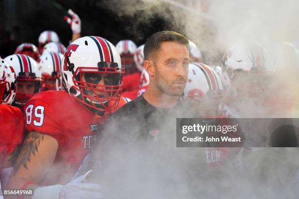 Head coach Kliff Kingsbury of the Texas Tech Red Raiders prepares to lead his team on to the field before the game between the Texas Tech Red Raiders...