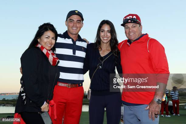 Rickie Fowler of the U.S. Team celebrates with his parents Lynn and Rod and girlfriend Allison Stokke after he and the U.S. Team defeated the...