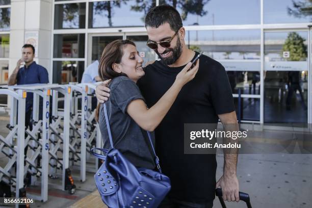 Arda Turan of Turkey hugs a woman as he arrives in Antalya with Turkish National Football Team ahead of the 2018 FIFA World Cup qualification Group I...