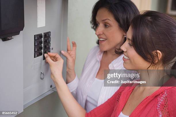 woman pushing switch in breaker box - fuse box stock pictures, royalty-free photos & images