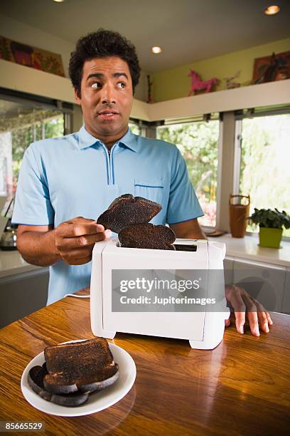 man burning toast - burnt bread stock pictures, royalty-free photos & images