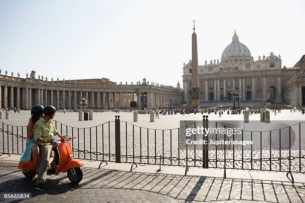 couple on motor scooter , saint peter's cathedral , vatican city , rome , italy - vatican city stock pictures, royalty-free photos & images