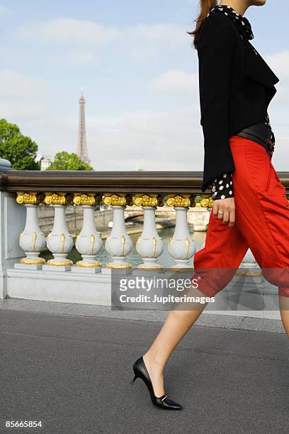 woman walking on bridge , paris , france - sassy paris stock pictures, royalty-free photos & images