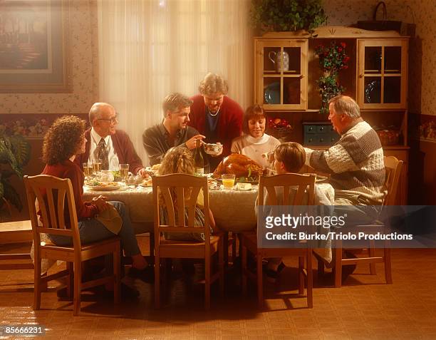 family at table together - warmes abendessen stock-fotos und bilder