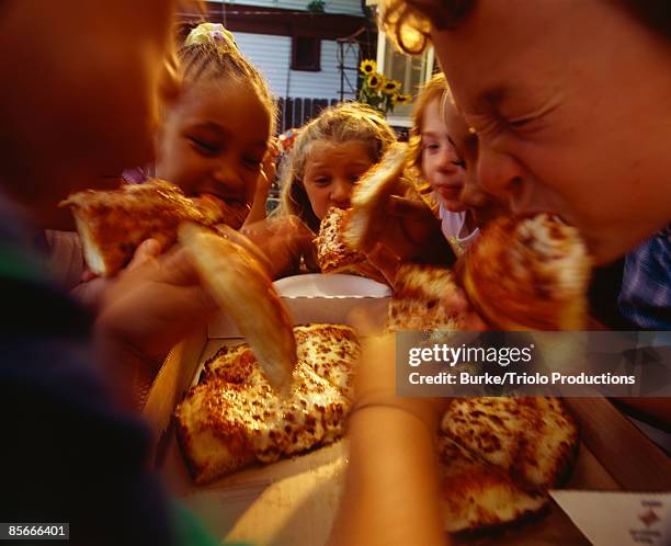 children eating pizza at a party - pizza party stock pictures, royalty-free photos & images