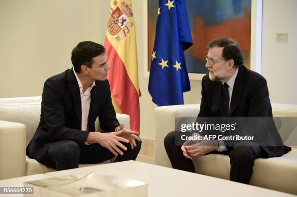 Spanish Prime Minister Mariano Rajoy speaks with Spanish Socialist Party PSOE leader Pedro Sanchez during their meeting at La Moncloa palace in...