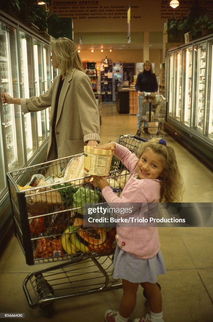 Mother and daughter shopping in market