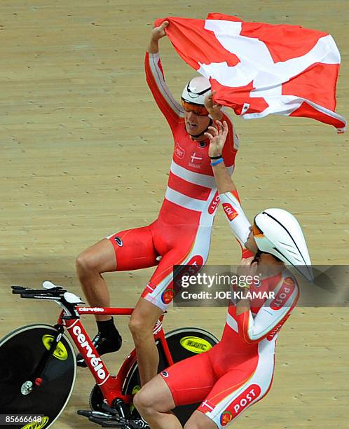 Denmark team's riders celebrate with national flag their gold medal in the men's team pursuit final during the UCI Track World Championships 2009 on...