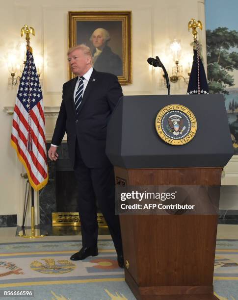 President Donald Trump leaves after delivering a statement on the Las Vegas shooting from the Diplomatic Reception Room of the White House on October...