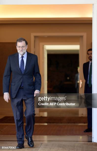 Spanish Prime Minister Mariano Rajoy comes out to receive Spanish Socialist Party PSOE leader prior to holding a meeting at La Moncloa palace in...
