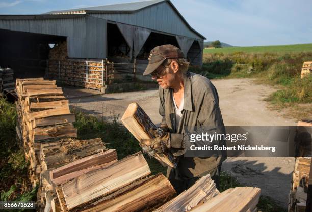 Robert Marble stacks firewood on his converted dairy farm in Charlotte, Vermont, September 26, 2017. Marble is a firewood supplier who has cut and...