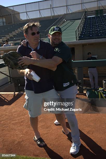General Manager Billy Beane and Jason Giambi of the Oakland Athletics on the field prior to the game against the Milwaukee Brewers at the Maryvale...
