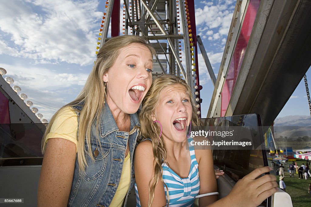 Mother and daughter screaming on ride