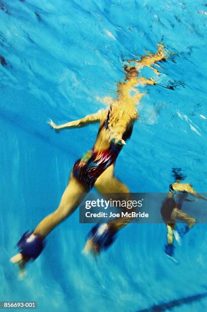 aqua aerobics, woman with floats wrapped around ankle - aquarobics stock-fotos und bilder
