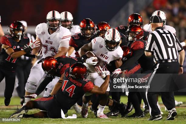 Jordan Huff of the Northern Illinois Huskies is tackled by Tariq Thompson of the San Diego State Aztecs in the fourth quarter during the Northern...