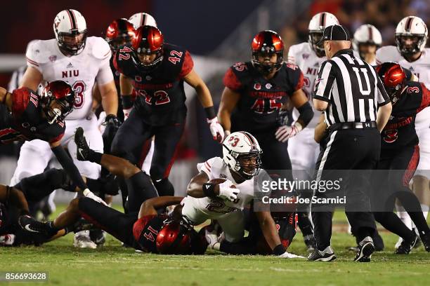 Jordan Huff of the Northern Illinois Huskies is tackled by Tariq Thompson of the San Diego State Aztecs in the fourth quarter during the Northern...