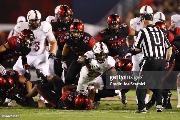 Jordan Huff of the Northern Illinois Huskies is tackled by Tariq Thompson of the San Diego State Aztecs in the fourth quarter during the Northern...