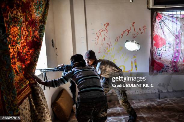 Members of the Syrian Democratic Forces , Syrian fighters backed by US special forces, monitor Islamic States positions from a newly taken area near...