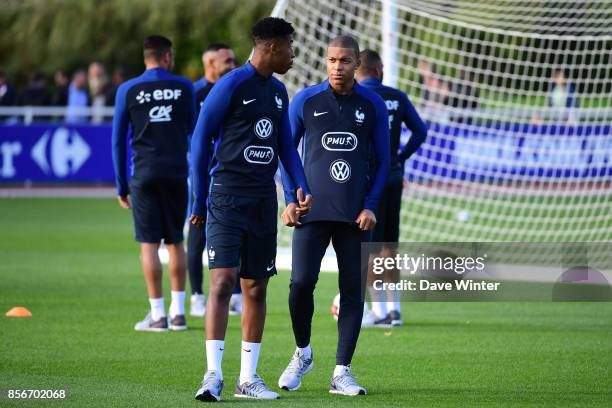 Teammates Kylian Mbappe of France and Presnel Kimpembe of France during the training session at Centre National du Football on October 2, 2017 in...