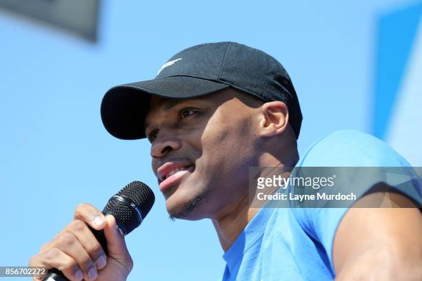 Russell Westbrook of the Oklahoma City Thunder speaks to a crowd of fans gathered for a pep rally to celebrate Westbrook signing a multi year...