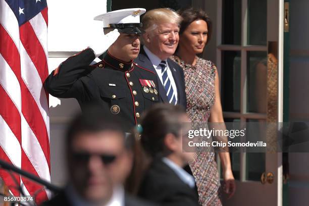 President Donald Trump and first lady Melania Trump walk out of the White House before greeting Prime Minister Prayut Chan-o-cha of Thailand October...