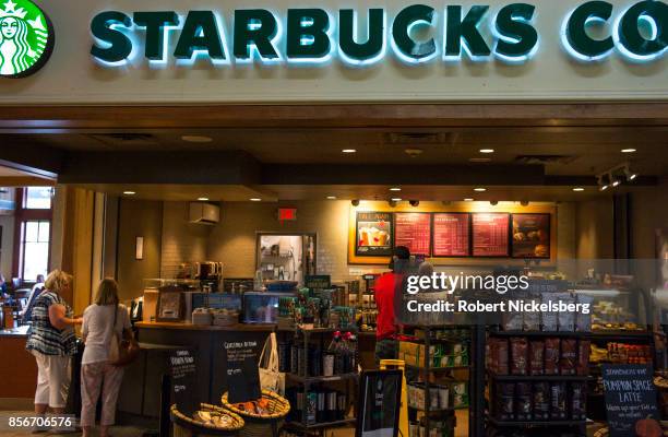 Customers stand in line at a Starbucks Coffee shop on the New York State Thruway in New Baltimore, New York, September 26, 2017. Starbucks was...