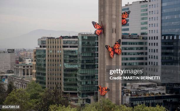 View of five giant butterflies that stand on the shaft of the Entel Tower--a symbol of modernity, communications and concrete of the city--is the...