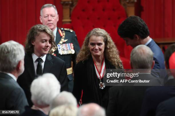 The newly sworn in Governor General Julie Payette and her son Laurier Payette Flynn walk by the Canadian Prime Minister Justin Trudeau in Senate in...
