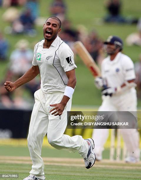 New Zealand cricketer Jeetan Patel celebrates the wicket of Indian batsman Sachin Tendulkar during the third day of the second Test match at the...