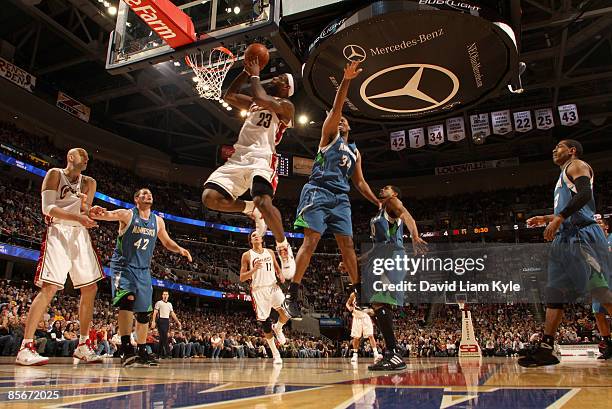 LeBron James of the Cleveland Cavaliers goes up for the basket defended by Jason Collins of the Minnesota Timberwolves at The Quicken Loans Arena on...