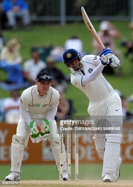 Indian cricketer Rahul Dravid plays a shot as New Zealand wicketkeeper Brendon McCullum looks on during the third day of the second Test match at the...