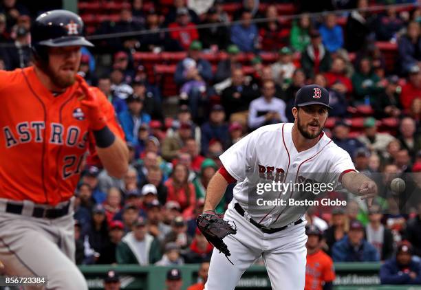 Houston Astros left fielder Derek Fisher beats the toss from Boston Red Sox starting pitcher Drew Pomeranz during the third inning. The Boston Red...