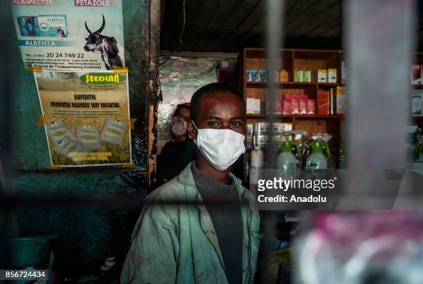 Man wearing a face mask works in Antananrivo, Madagascar as plague spreads rapidly in cities across the country on October 2, 2017. Twenty people...
