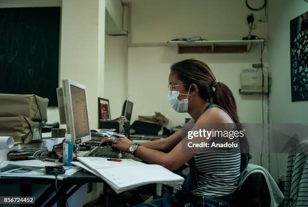 Woman wearing a face mask works in Antananrivo, Madagascar as plague spreads rapidly in cities across the country on October 2, 2017. Twenty people...