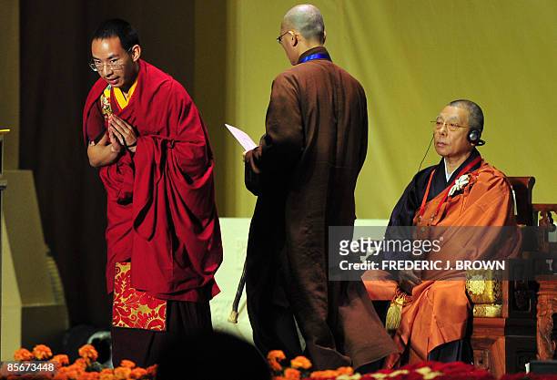 China's controversial choice as the second highest Tibetan spiritual figure, the 19-year-old Panchen Lama , gestures to the audience before...
