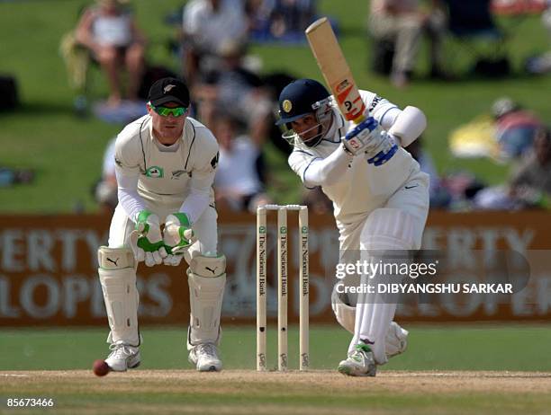 Indian cricketer V.V.S Laxman plays a shot as New Zealand wickekeeper Brendon McCullum looks on during the third day of the second Test match at the...