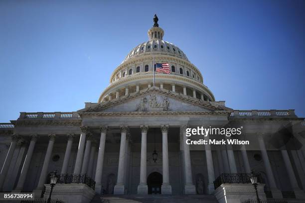An American flag flies at half-staff at the U.S. Capitol, on October 2, 2017 in Washington, DC. President Donald Trump ordered the flags on all...