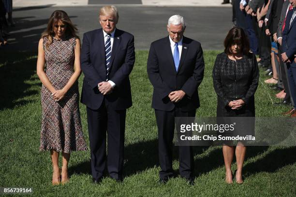 First lady Melania Trump, U.S. President Donald Trump, Vice President Mike Pence and Karen Pence observe a moment of silence on the South Lawn of the...