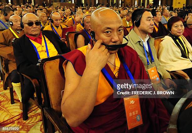 Buddhist monks use headsets for translations of speeches at the opening session of the World Buddhist Forum on March 28, 2009 in Wuxi, in eastern...