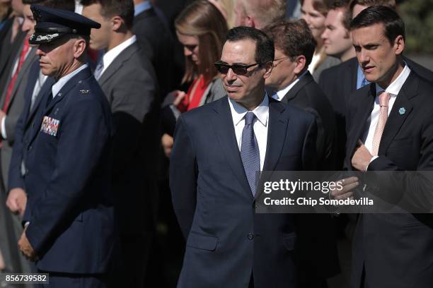 Treasury Secretary Steven Mnuchin and White House Homeland Security Advisor Tom Bossert prepare to observe a moment of silence on the South Lawn of...
