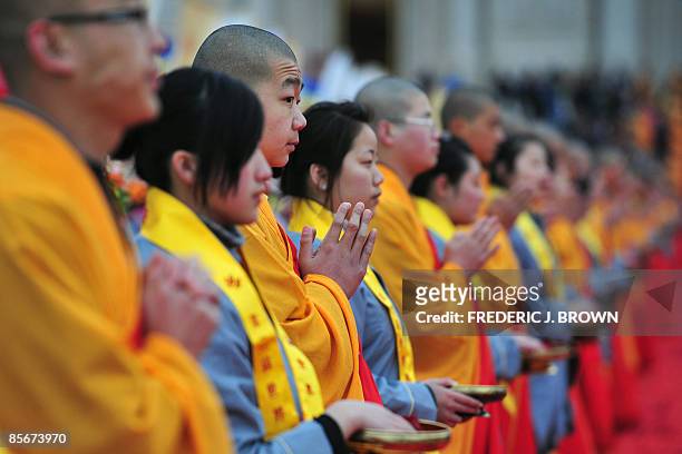 Buddhist monks and volunteers greet arriving guests for the opening session of the World Buddhist Forum on March 28, 2009 in Wuxi, in eastern China's...