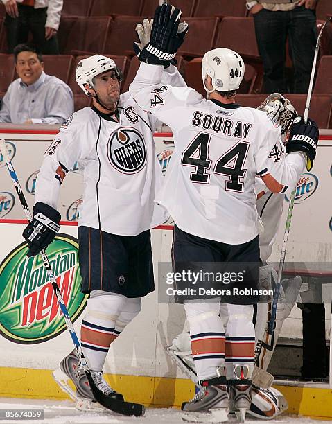 Ethan Moreau and Sheldon Souray of the Edmonton Oilers high five after a win against the Anaheim Ducks during the game on March 27, 2009 at Honda...