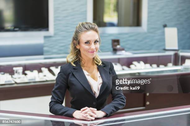 saleswoman working in jewelry store - jeweller stock pictures, royalty-free photos & images