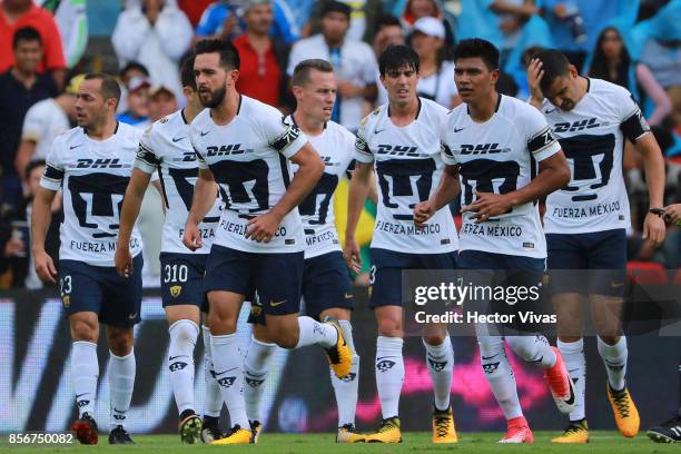 Luis Quintana of Pumas celebrates with teammates after scoring the first goal of his team during the 12th round match between Pumas UNAM and Cruz...