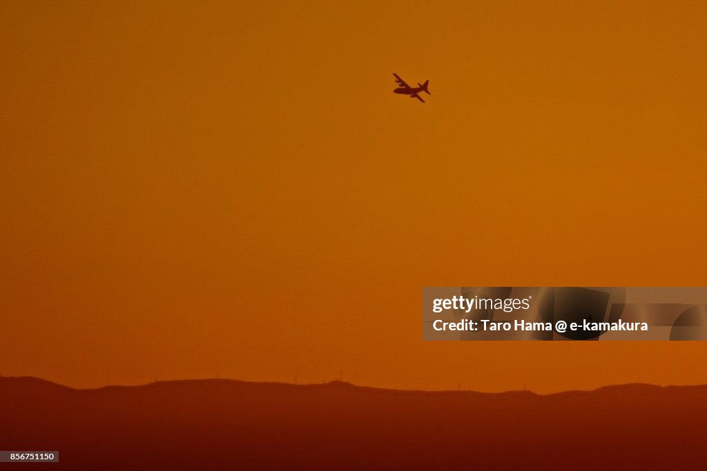 An airplane flying on Izu Peninsula in the sunset
