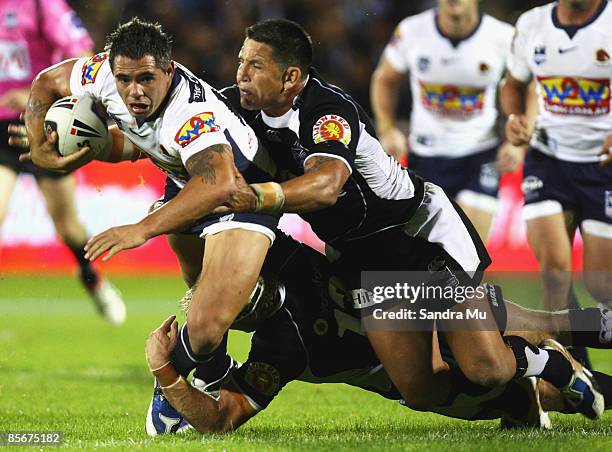 Corey Parker of the Broncos gets tackled by Steve Price of the Warriors during the round three NRL match between the Warriors and Brisbrine Broncos...