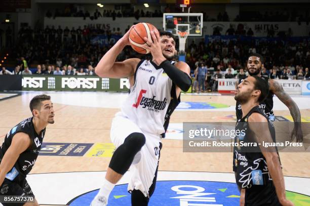 Alessandro Gentile of Segafredo competes with Diego Flaccadori and Yannick Franke and Chane Behanan of Dolomiti Energia during the LBA LegaBasket...